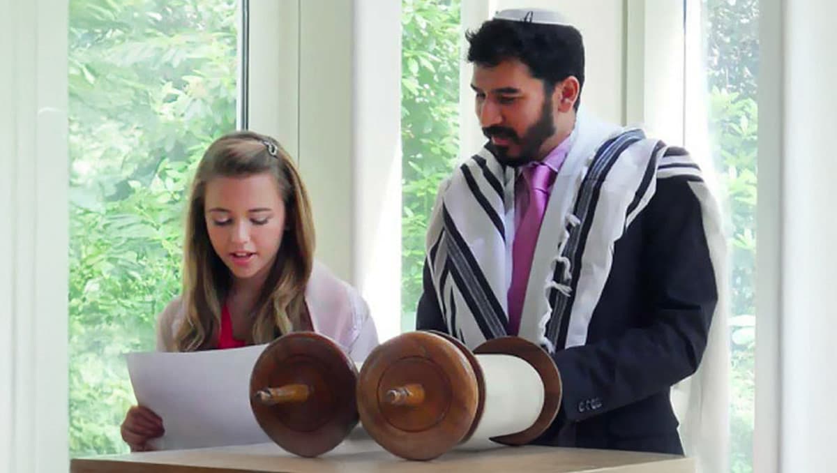 Father and daughter reading Torah