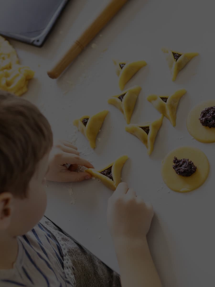 Child making hamantaschen
