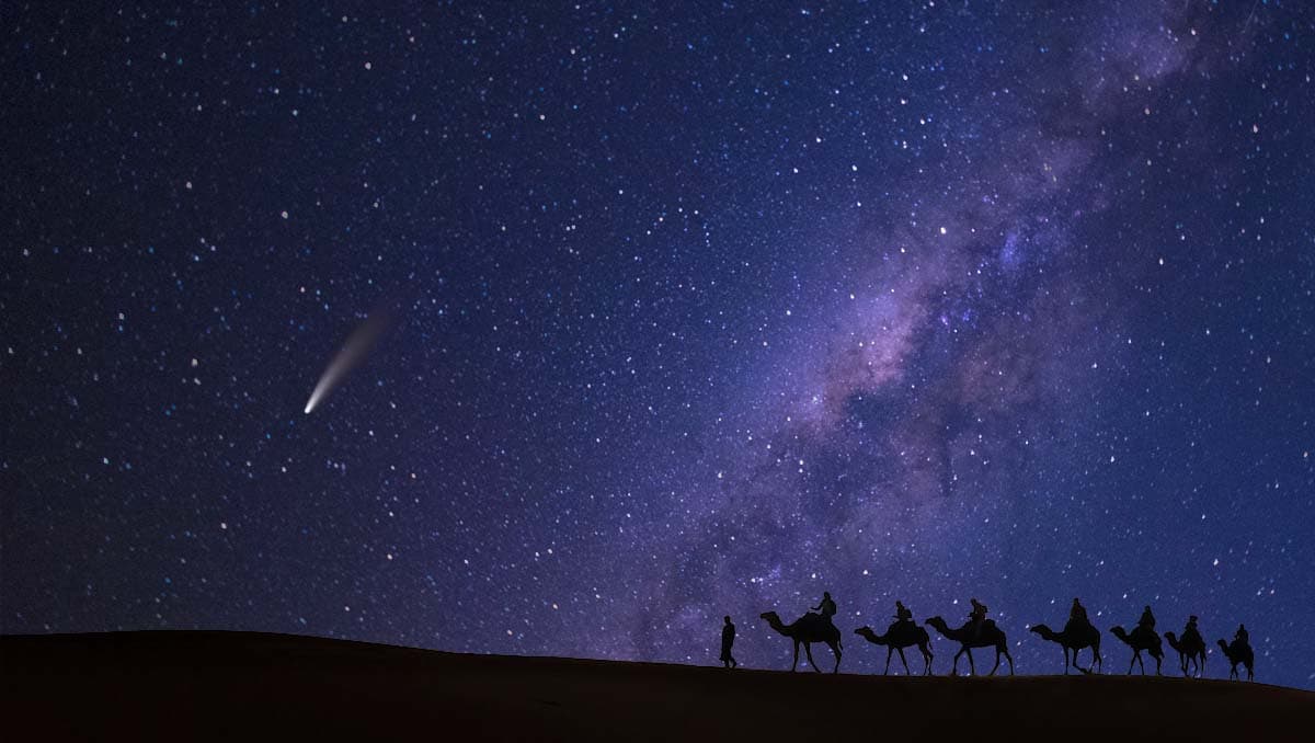 Camel procession at night with comet