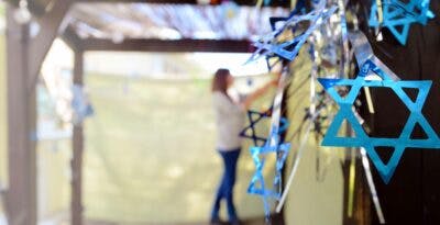 Woman decorating a sukkah